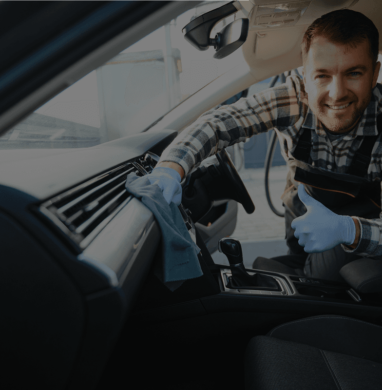 Car wash professional cleaning a vehicle